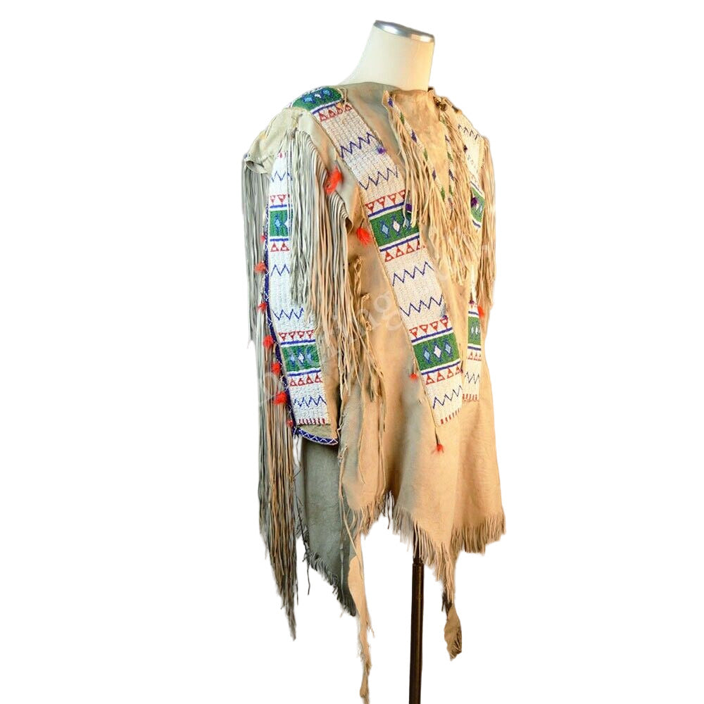 Traditional Native American garment with intricate patterns and fringes on a mannequin against a neutral background.