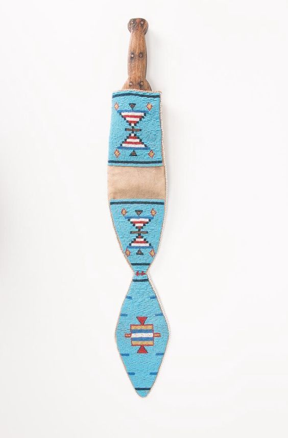 Decorative knife sheath with blue and beige pattern on a white background