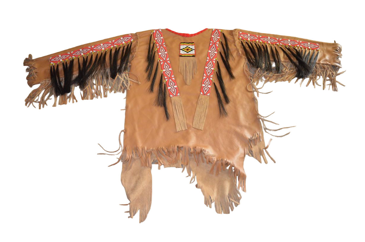 Traditional Native American garment with fringes and embroidery on a beige carpet