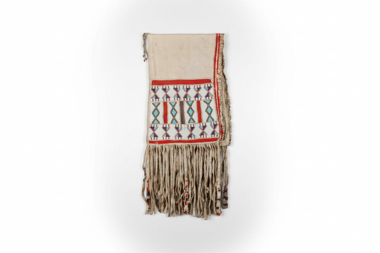 Decorative saddle bag with geometric patterns and fringes on a white background
