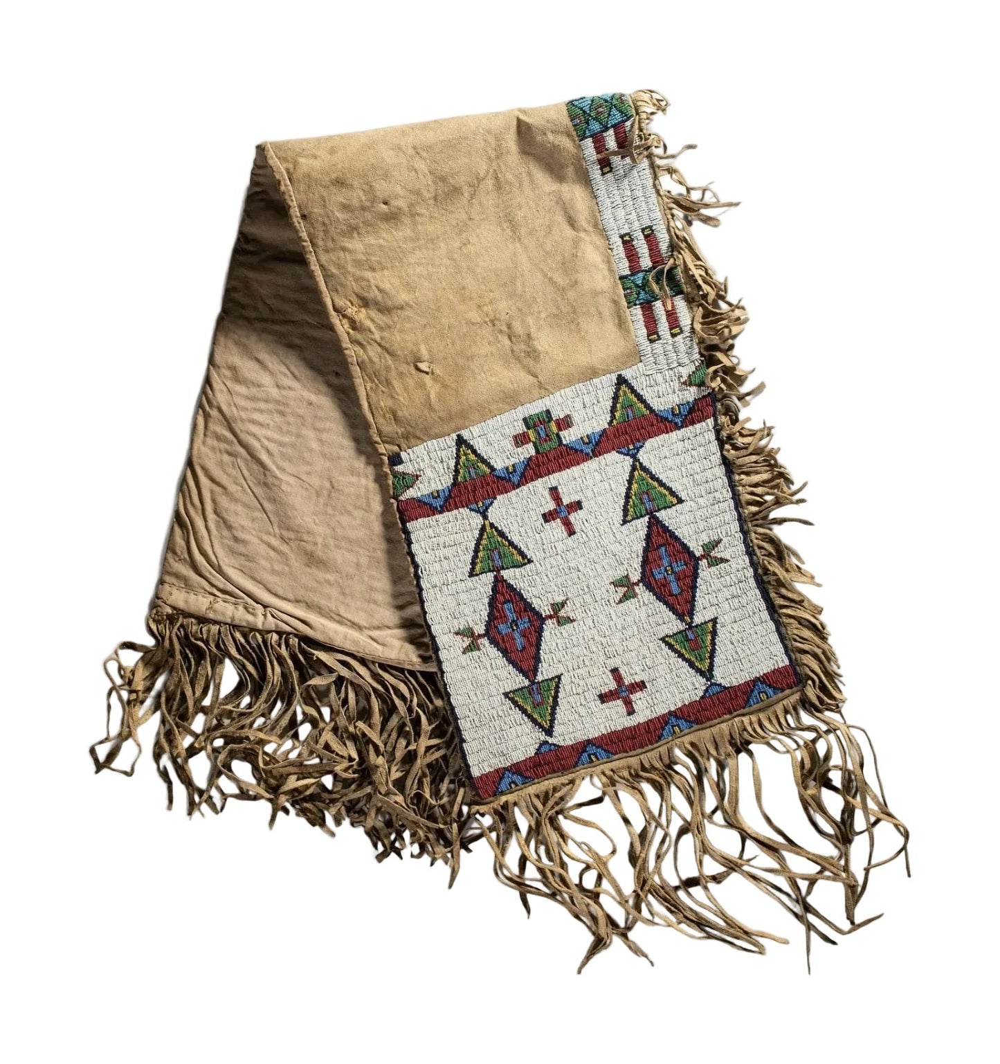 saddle bag with geometric patterns and fringes on a white background