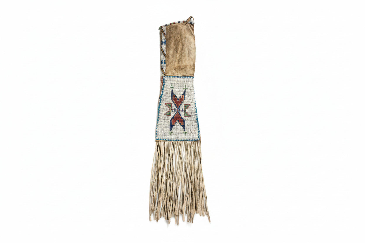Traditional beaded and fringed garment on a white background