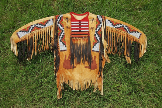 Traditional Native American-style War Shirt with intricate patterns and fringes on a Grassy background