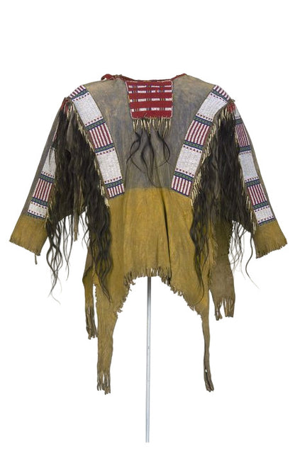 Traditional Native American garment with fringes and patterns on a white background