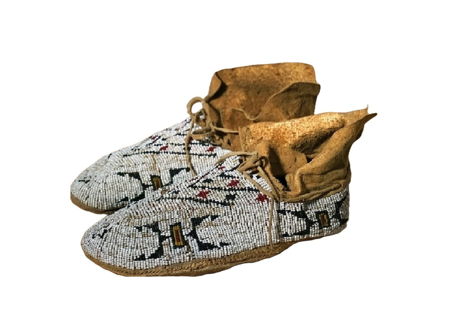 Pair of Native American beaded moccasins on a white background