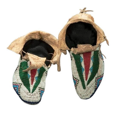 Pair of Native American beaded moccasins on a white background