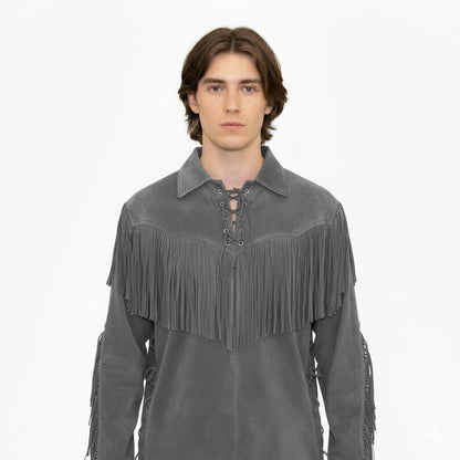 Man wearing a gray suede fringe jacket on a white background