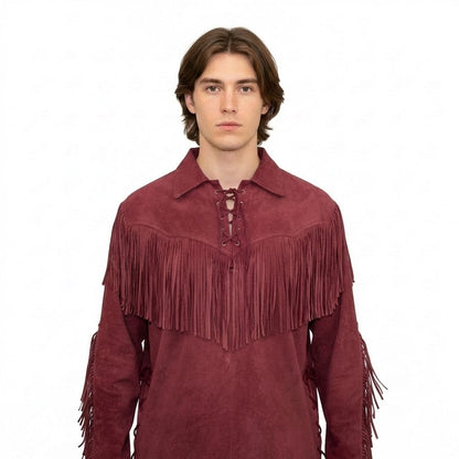 Man wearing a maroon suede shirt with fringes on a white background