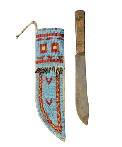 Decorative knife sheath with tribal patterns and a knife on a white background
