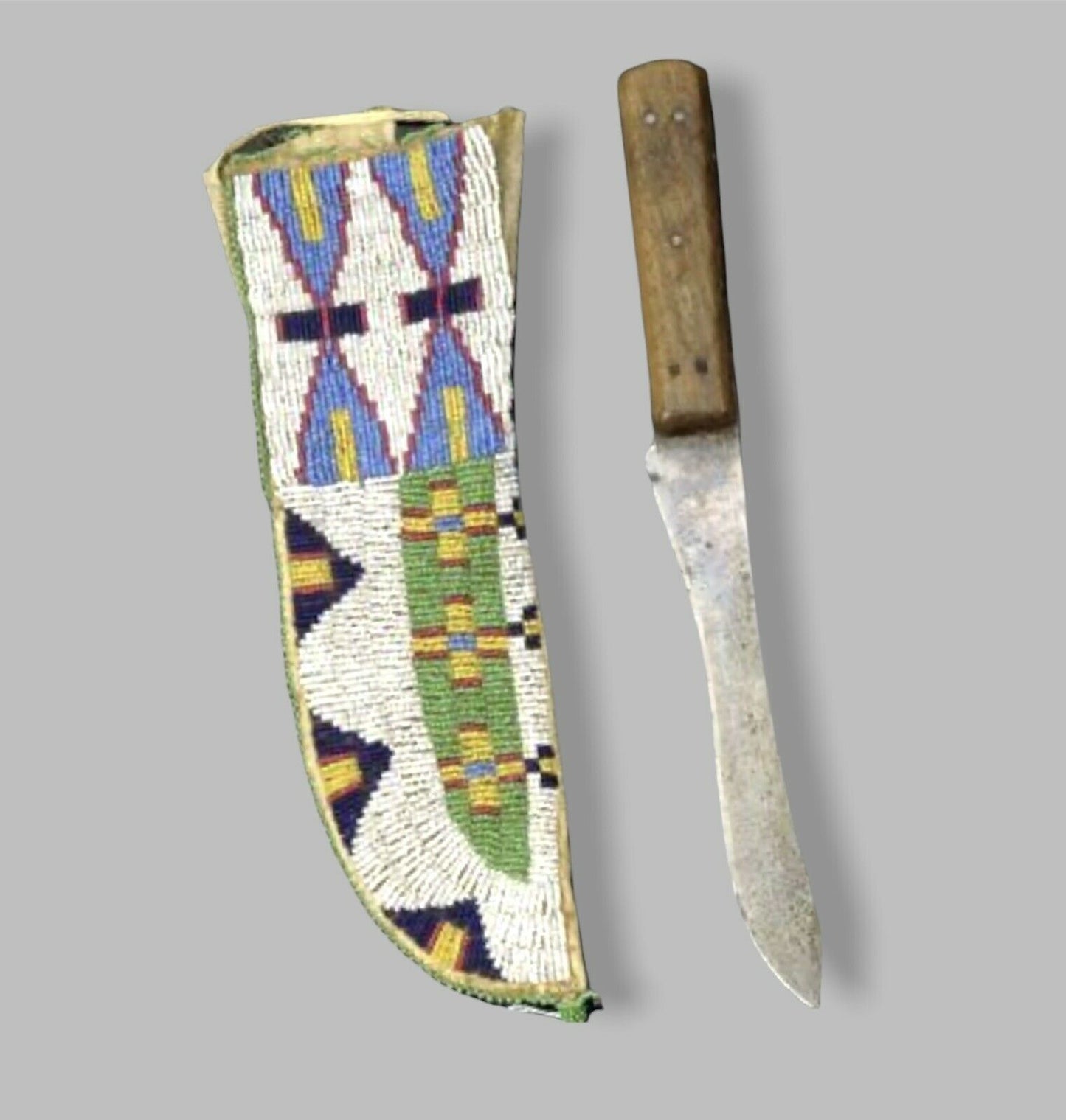 Decorative knife sheath with geometric patterns next to a knife on a gray background