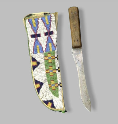 Decorative knife sheath with geometric patterns next to a knife on a gray background