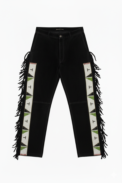 Black jeans with geometric patterned side panels and fringes on a white background