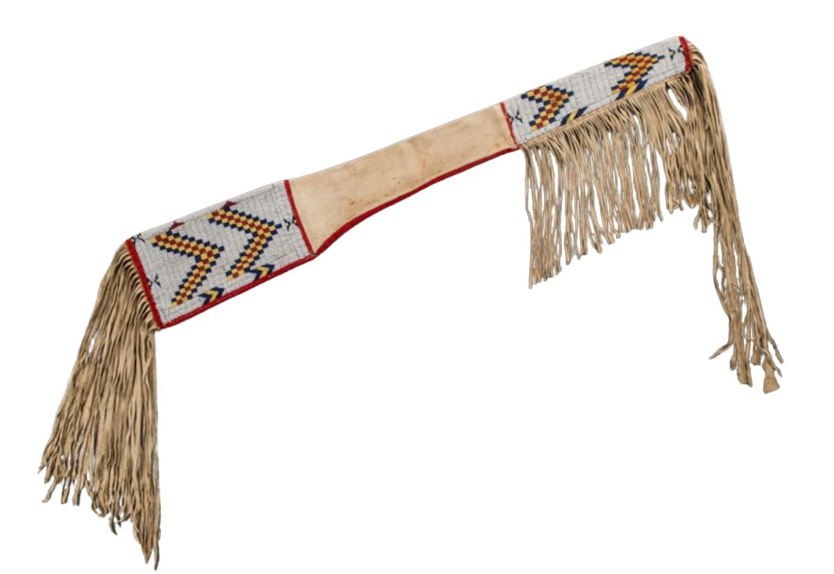 Decorative rifle sheath with fringes and geometric patterns on a white background