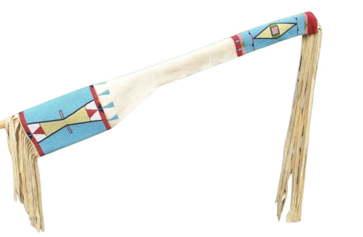Decorative sheath with colorful patterns and fringes on a white background 
