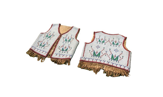 Sioux beaded vests with fringes on a white background