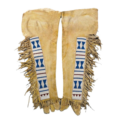Pair of Native American-style leggings with fringes and decorative patterns on a white background