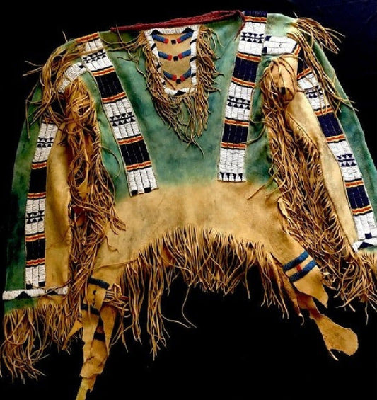 Traditional Native American headdress with intricate patterns and fringes on a dark background
