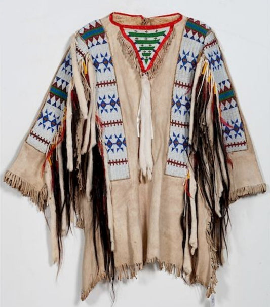 Traditional Native American garment with intricate patterns and fringes on a white background