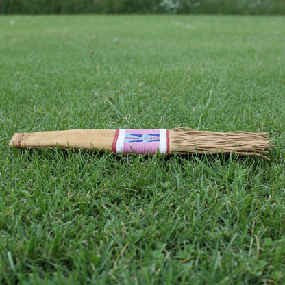Pipe Bag with a colorful handle on grass