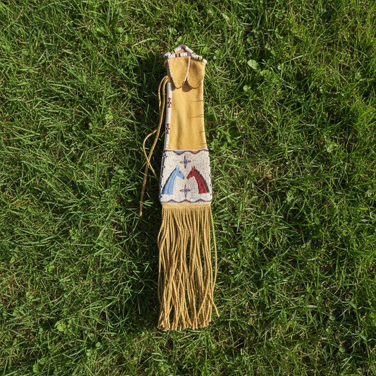 Decorative Pipe Bag with beadwork on a grassy background
