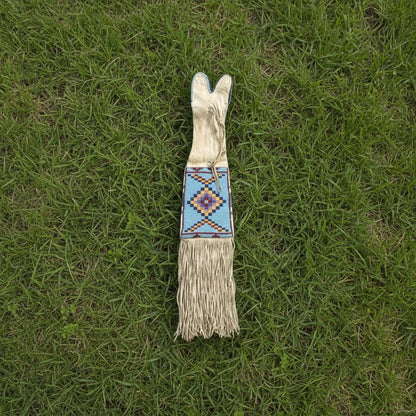 Decorative Pipe Bag with a colorful handle on grass