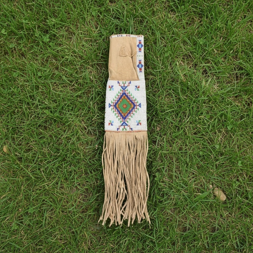 Decorative Pipe Bag with fringes and beadwork on a grassy background