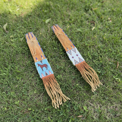 Two decorative horse Pipe Bag with fringes on a grassy background