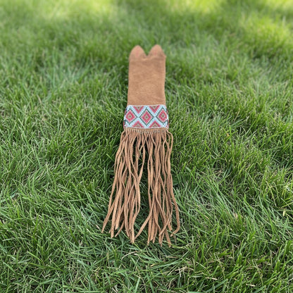 Decorative Pipe Bag with fringes on a grassy background