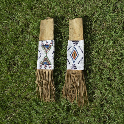 pipe bag with beaded top sections on a grassy background