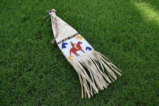 Decorative bag with horse designs and fringes on a white background