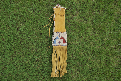 Decorative bag with fringes and beadwork on a white background