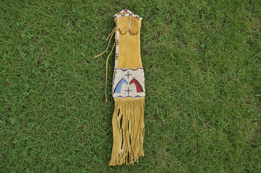 Decorative bag with fringes and beadwork on a white background