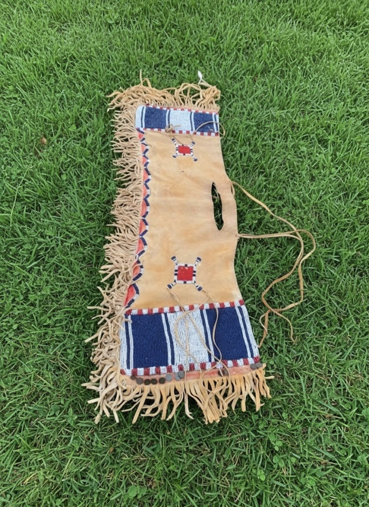 Decorative bag with fringes on a grassy background