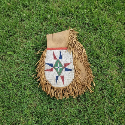 Decorative bag with fringe and star pattern on grass