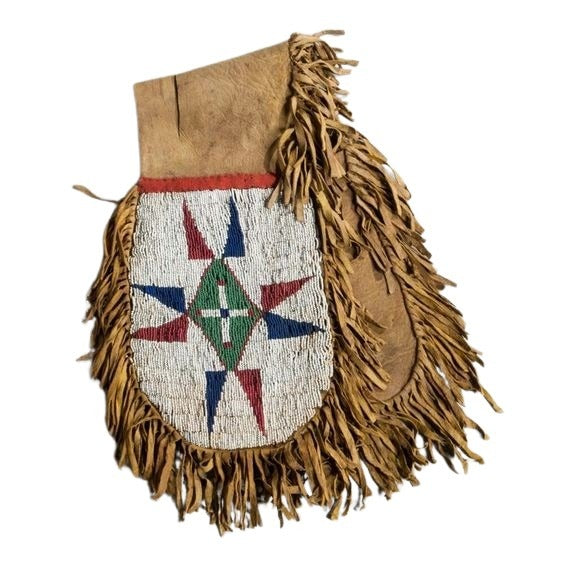 Decorative bag with fringes and geometric patterns on a white background