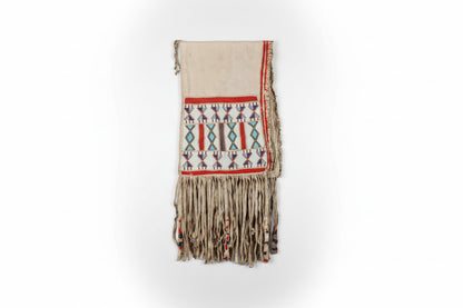 Decorative saddle bag with geometric patterns and fringes on a white background