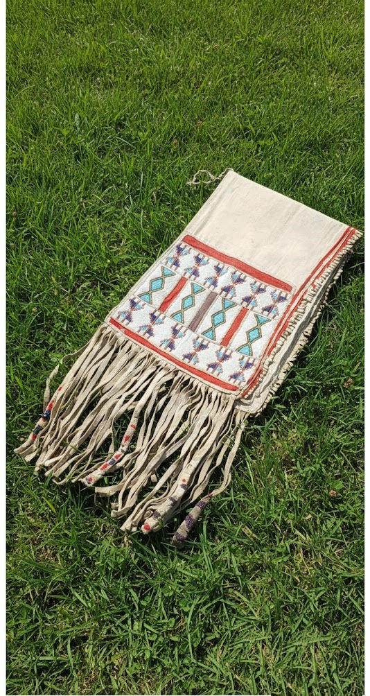 Textile with geometric pattern and fringes on grass