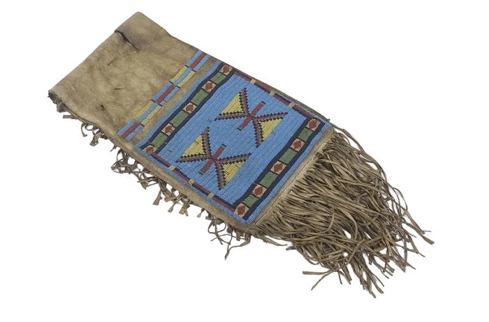saddle bag with geometric patterns and fringes on a white background
