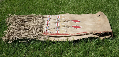 Traditional Native American Bag with fringes on a grassy background