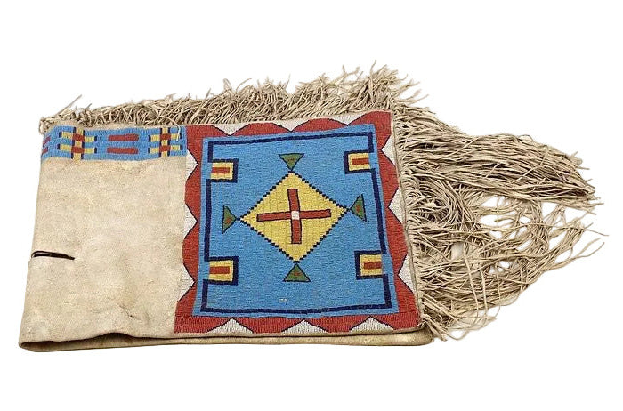 Decorative saddle bag with geometric pattern and fringes on a white background