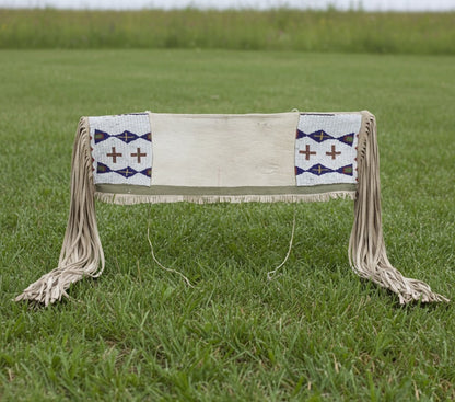 Decorative Bag with geometric patterns and fringes on a grassy field
