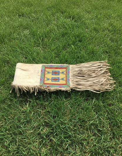 Textile with a colorful pattern on grass