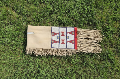 Textile with geometric patterns and fringes on grass