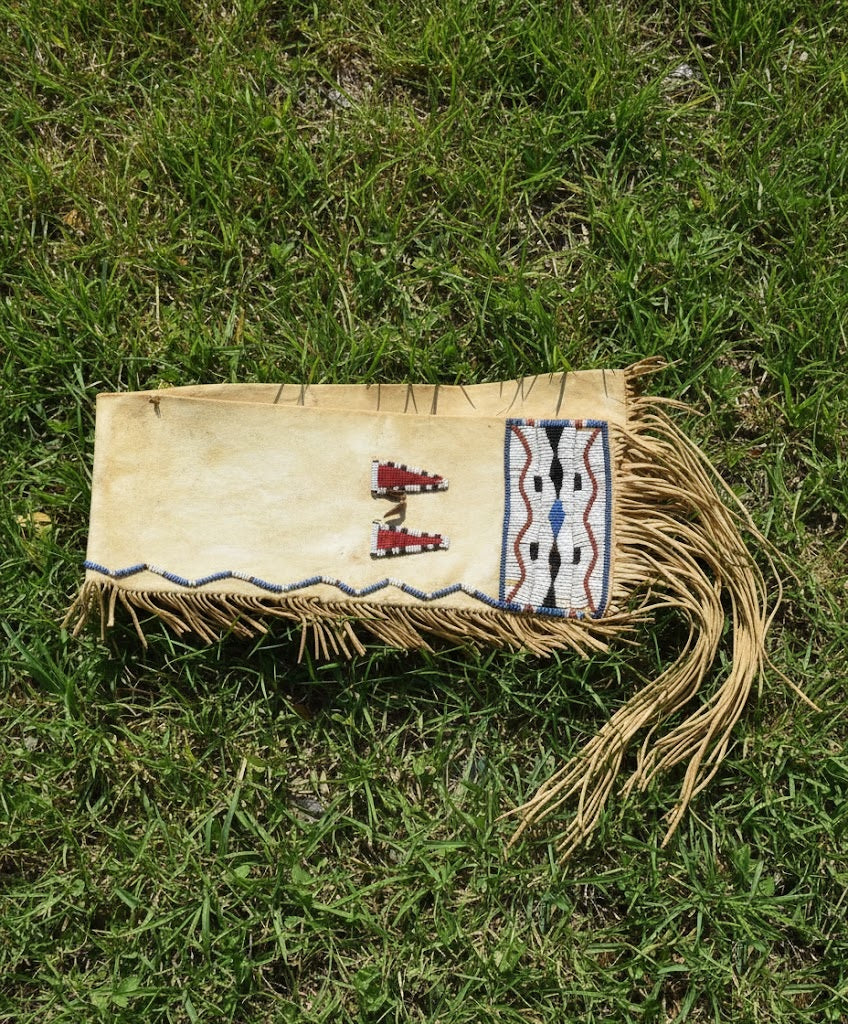 Handmade leather Bag with beadwork on grass
