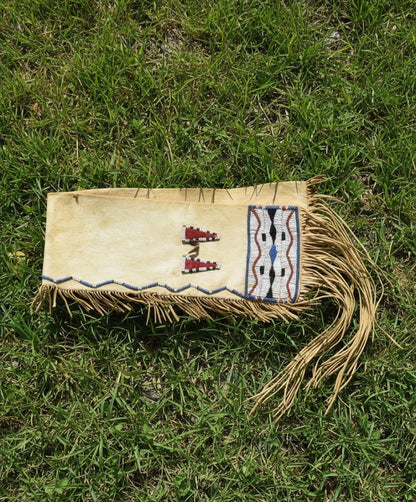 Handmade leather Bag with beadwork on grass
