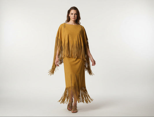 tan yellow suede fringe garment on a mannequin against a floral wallpaper background