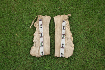 Pair of traditional Native American leggings with decorative bands on a white background