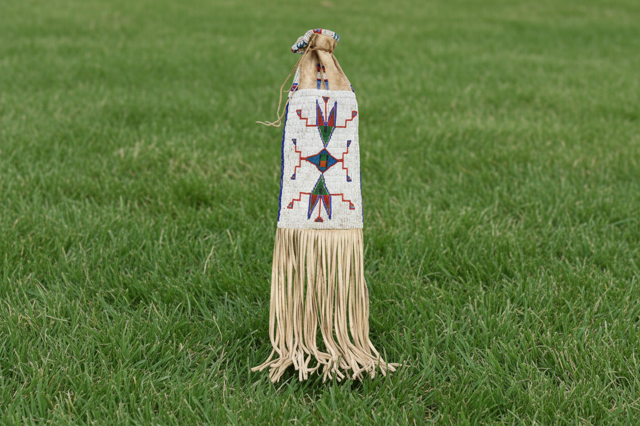 Decorative bag with beadwork and fringes on a white background