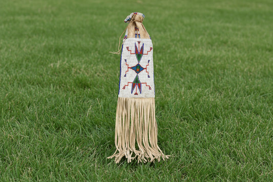 Decorative bag with beadwork and fringes on a white background