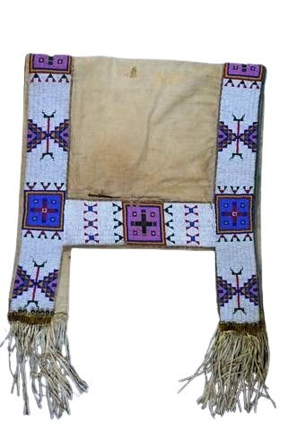 Traditional woven saddle blanket with geometric patterns and fringes on a white background